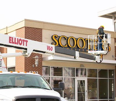 Business signage maintenance of large outdoor sign
